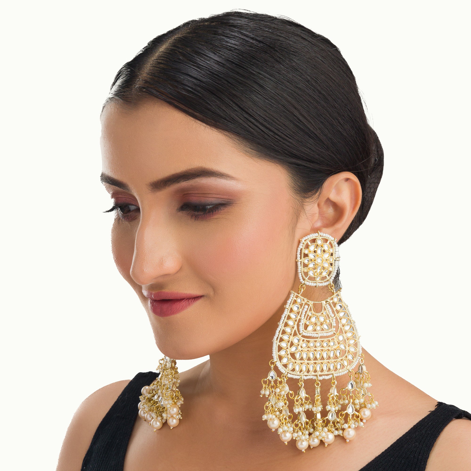 "Wheat-colored Kundan earrings make a bold, elegant statement."
