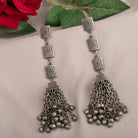 Oxidized long earrings add tribal charm, perfect for a festive occasion.

