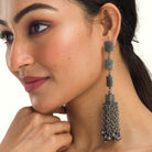 Oxidized long earrings add tribal charm, perfect for a festive occasion.
