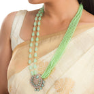 "Light green pearl long necklace in rose gold for a fresh, elegant look."
