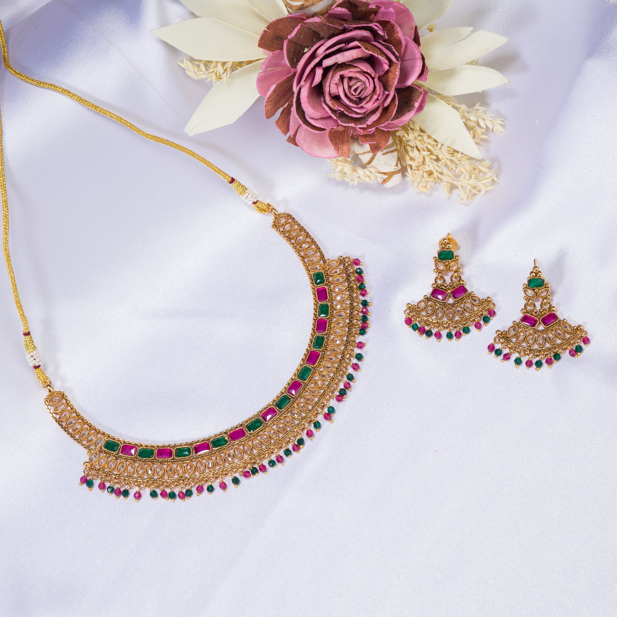 "Gold-tone necklace with multi-color stones adds vibrant style and festive charm."
