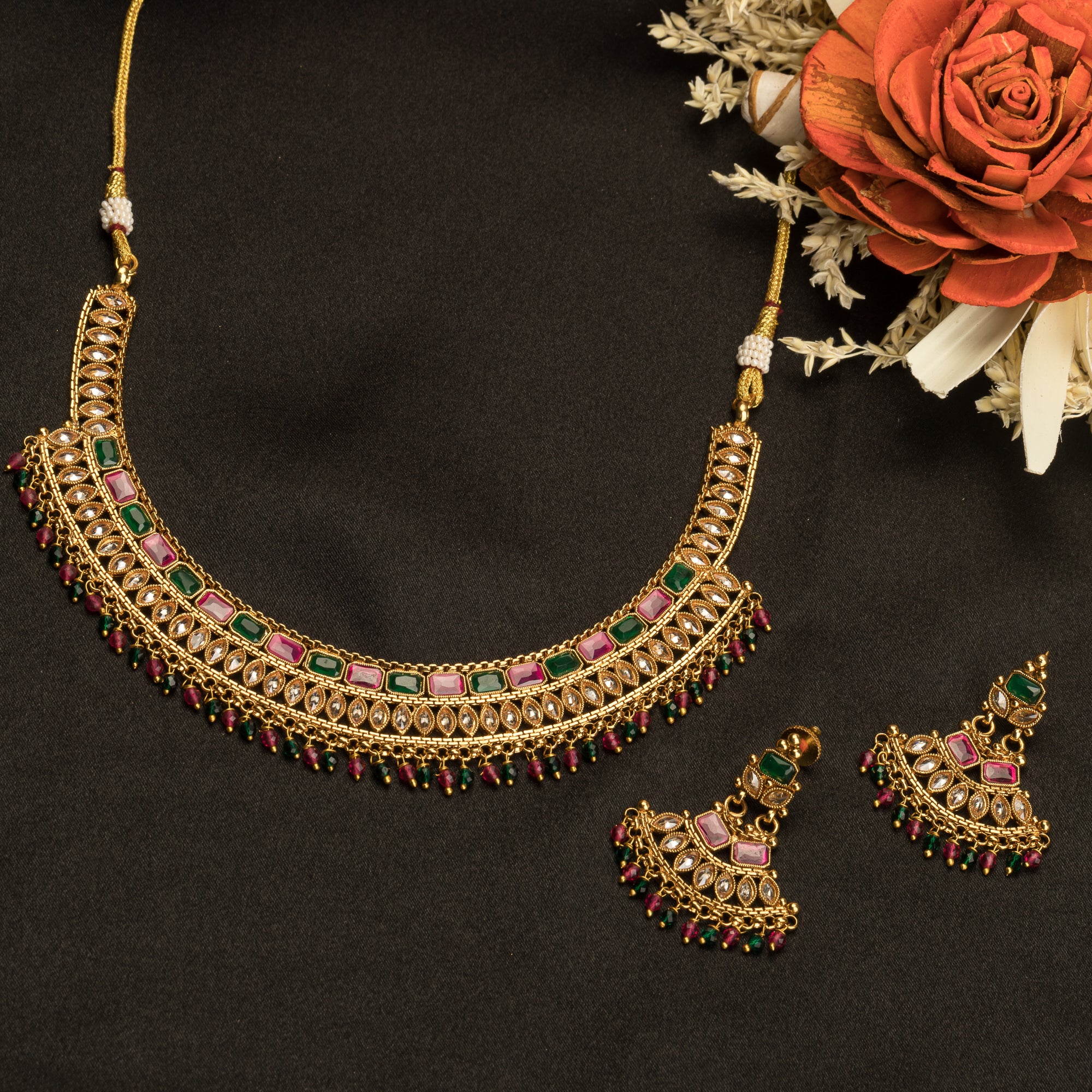 "Gold-tone necklace with multi-color stones adds vibrant style and festive charm."
