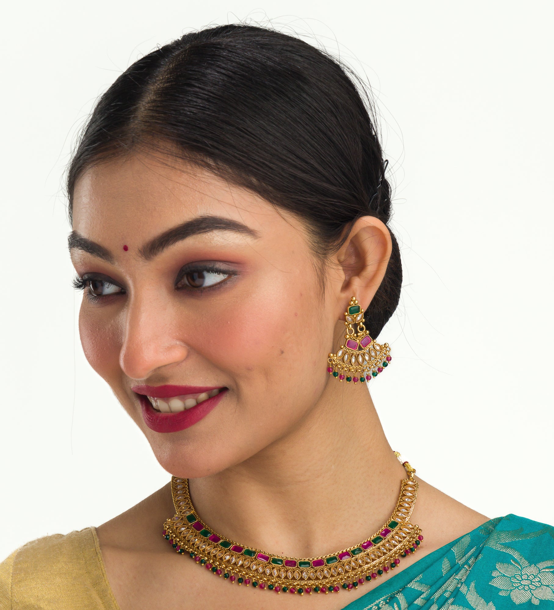 "Gold-tone necklace with multi-color stones adds vibrant style and festive charm."
