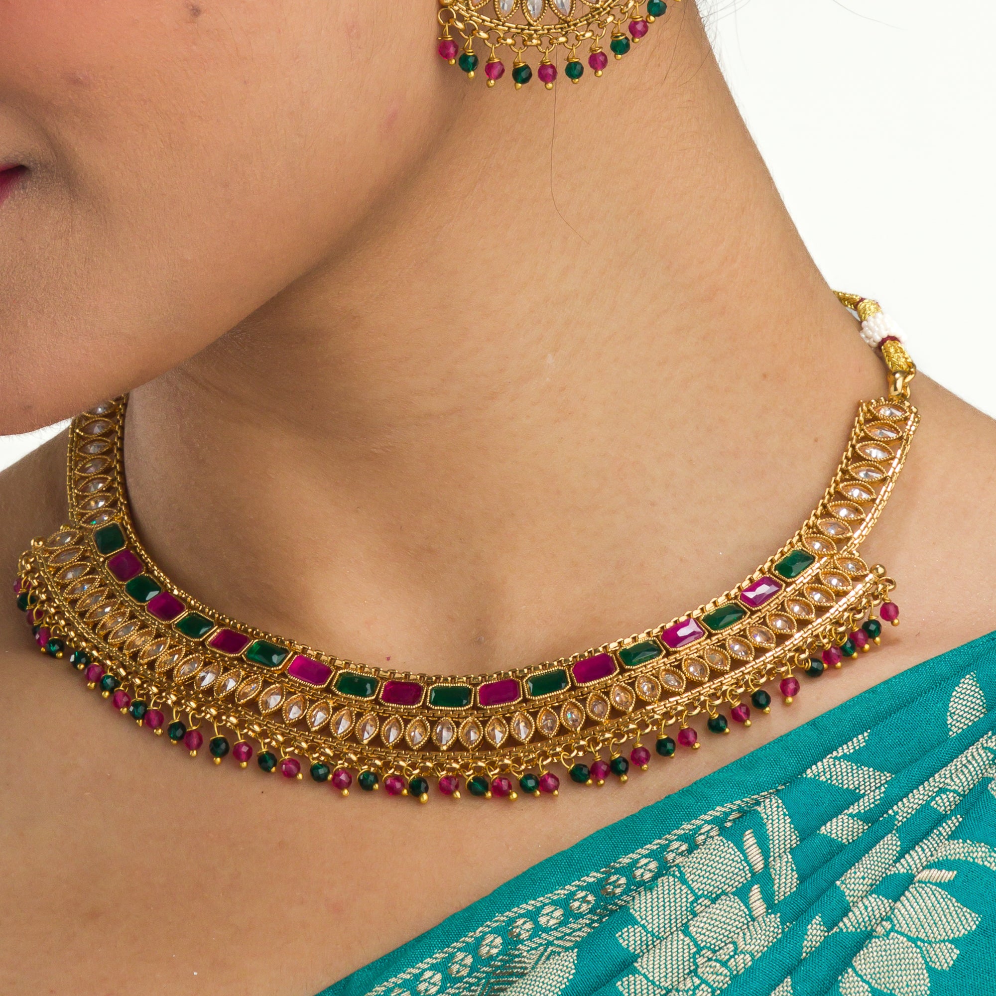 "Gold-tone necklace with multi-color stones adds vibrant style and festive charm."
