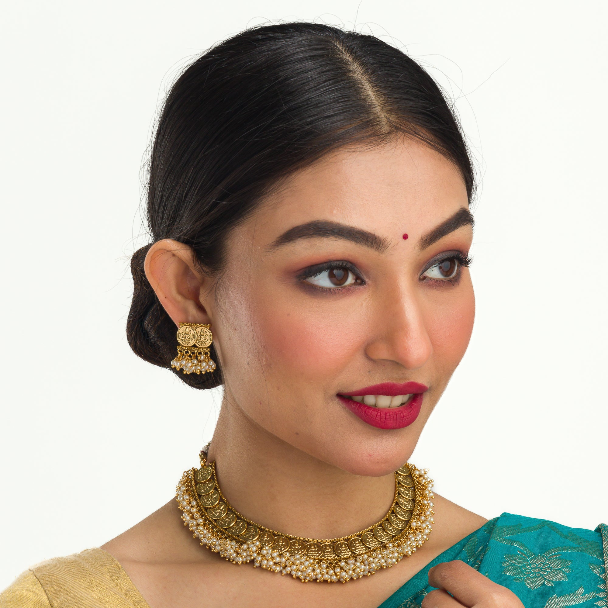 Gold-tone necklace with coin design and pearls exudes timeless elegance.
