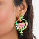 Green and pink Meenakari earrings feature colorful enamel for a traditional look.
