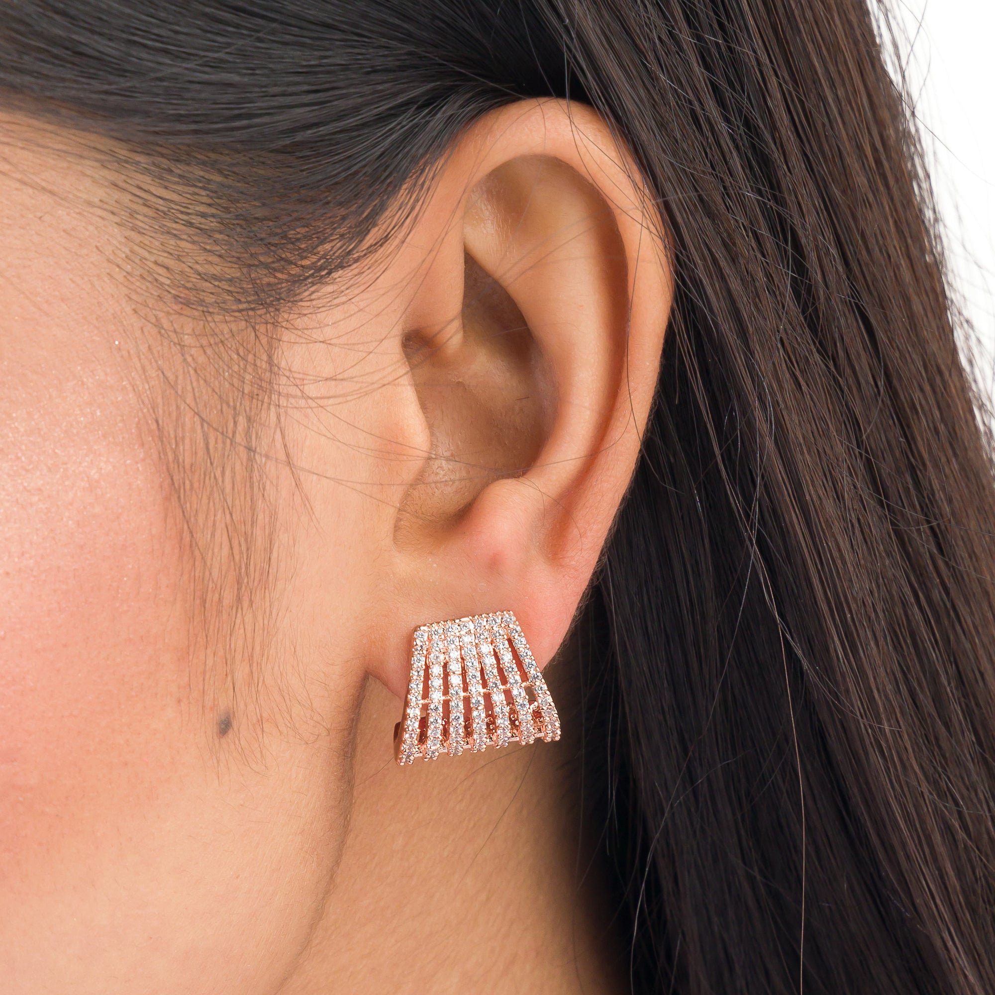 Trendy zircon studs with rose gold polish add a sleek and modern touch.
