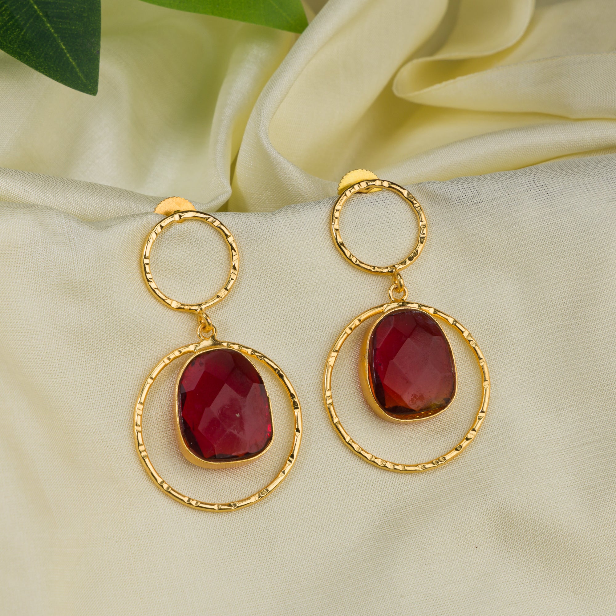 Bold gold-tone dangler earrings with red stone for a striking, luxurious look
