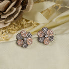 "Zircon flower-shaped earrings with rose gold polish combine warmth and vibrant sparkle."
