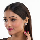 "Zircon flower-shaped earrings with rose gold polish combine warmth and vibrant sparkle."
