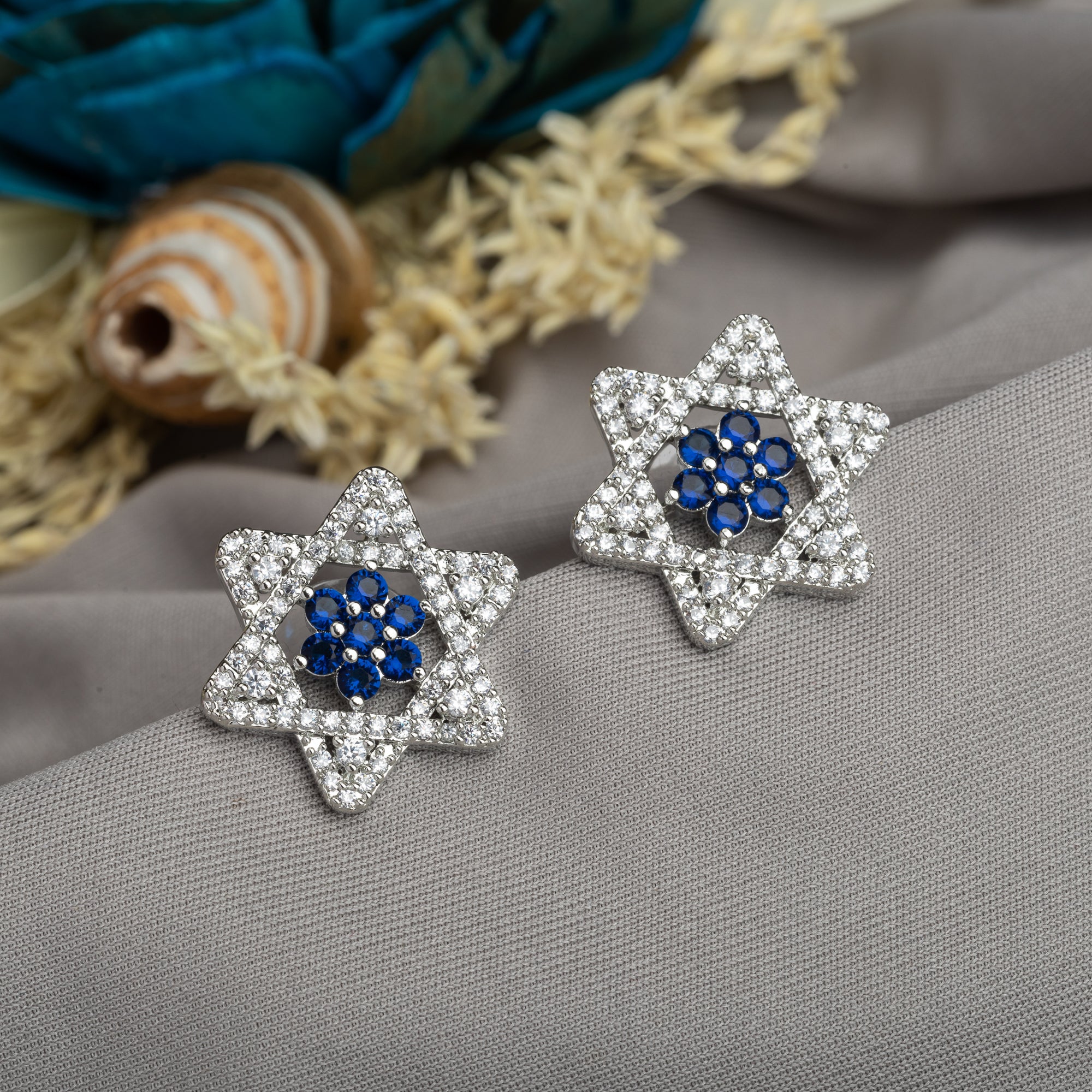 "Blue zircon stud earrings with a starry design add vibrant color and elegant sparkle to your style."
