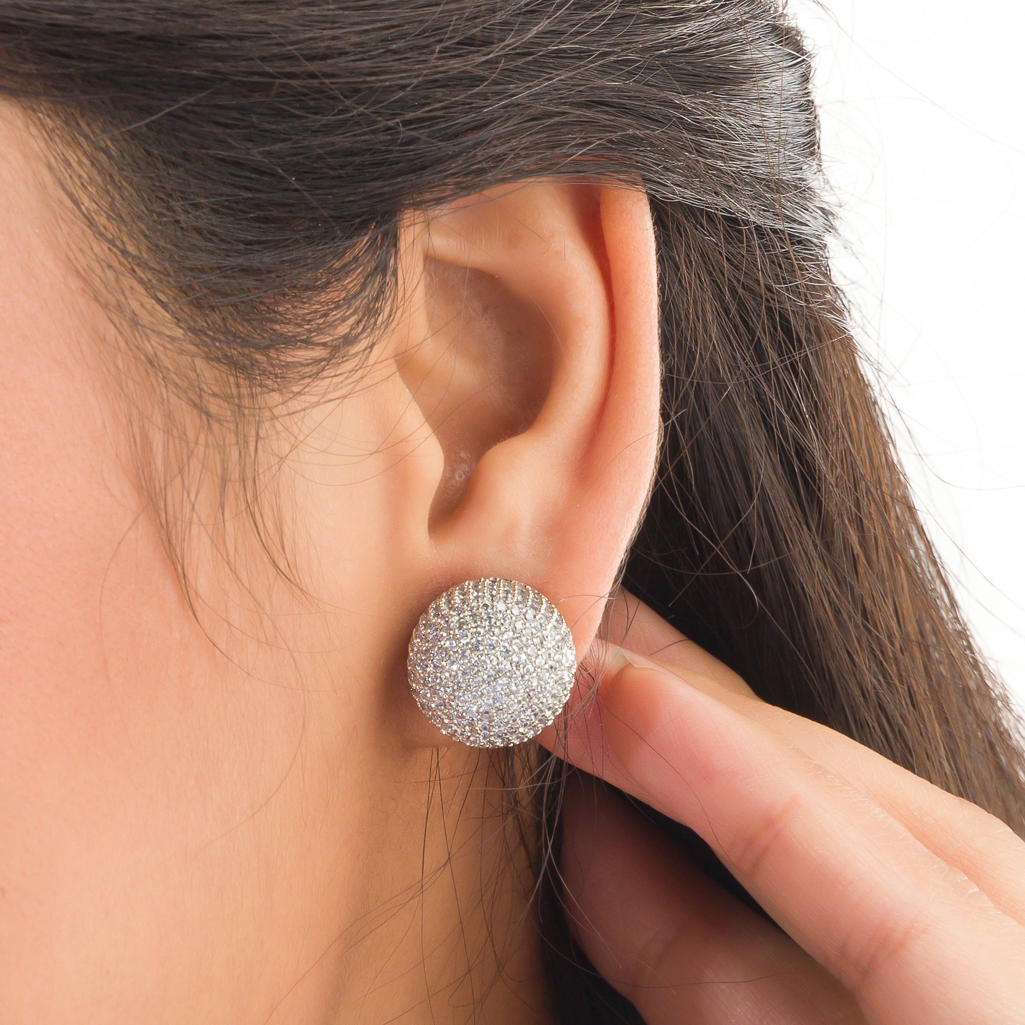 "Timeless zircon stud earrings with brilliant sparkle add versatile elegance to any outfit."
