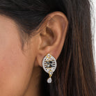  "Zircon earrings with a golden touch combine sparkling brilliance and a warm, luxurious finish."

