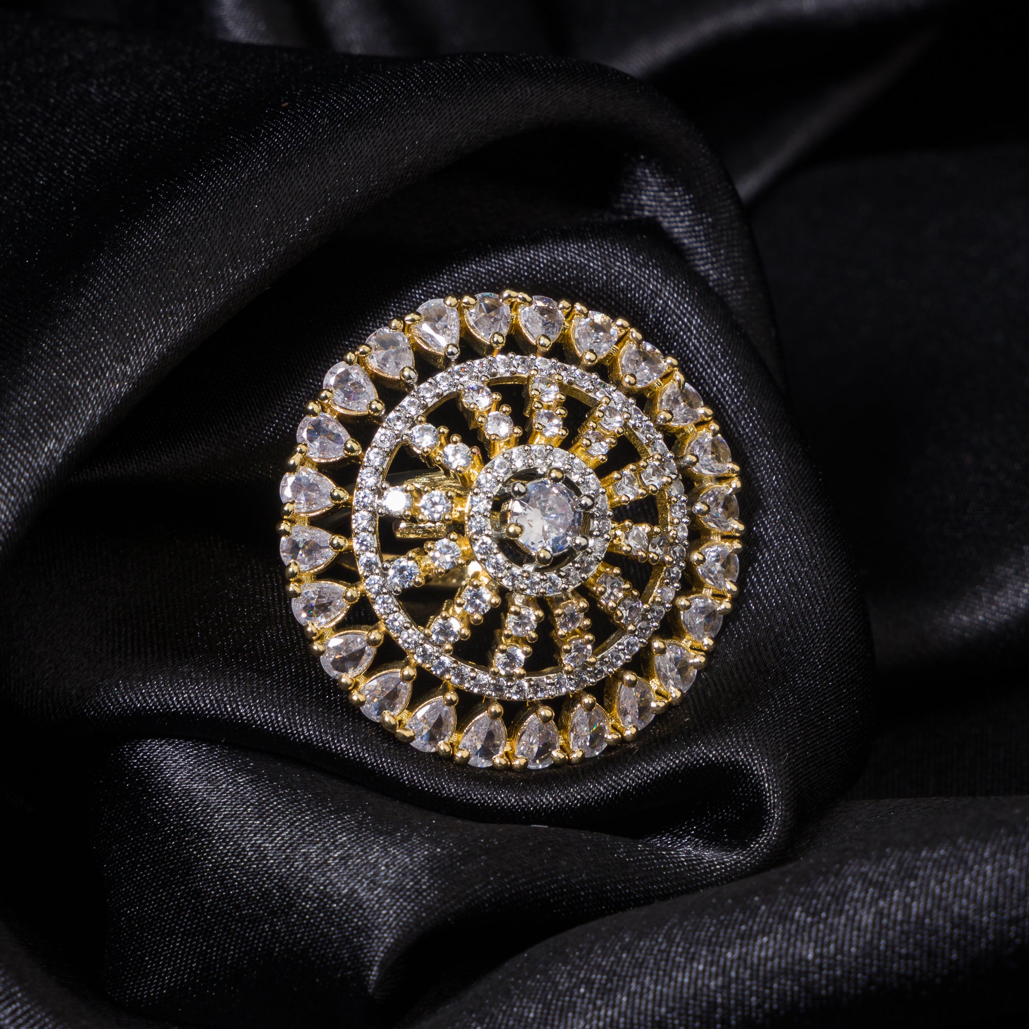Golden zircon finger ring combines luxurious sparkle with a timeless gold-tone finish.
