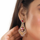 Red zircon bridal necklace set features intricate designs, perfect for a regal wedding look.
