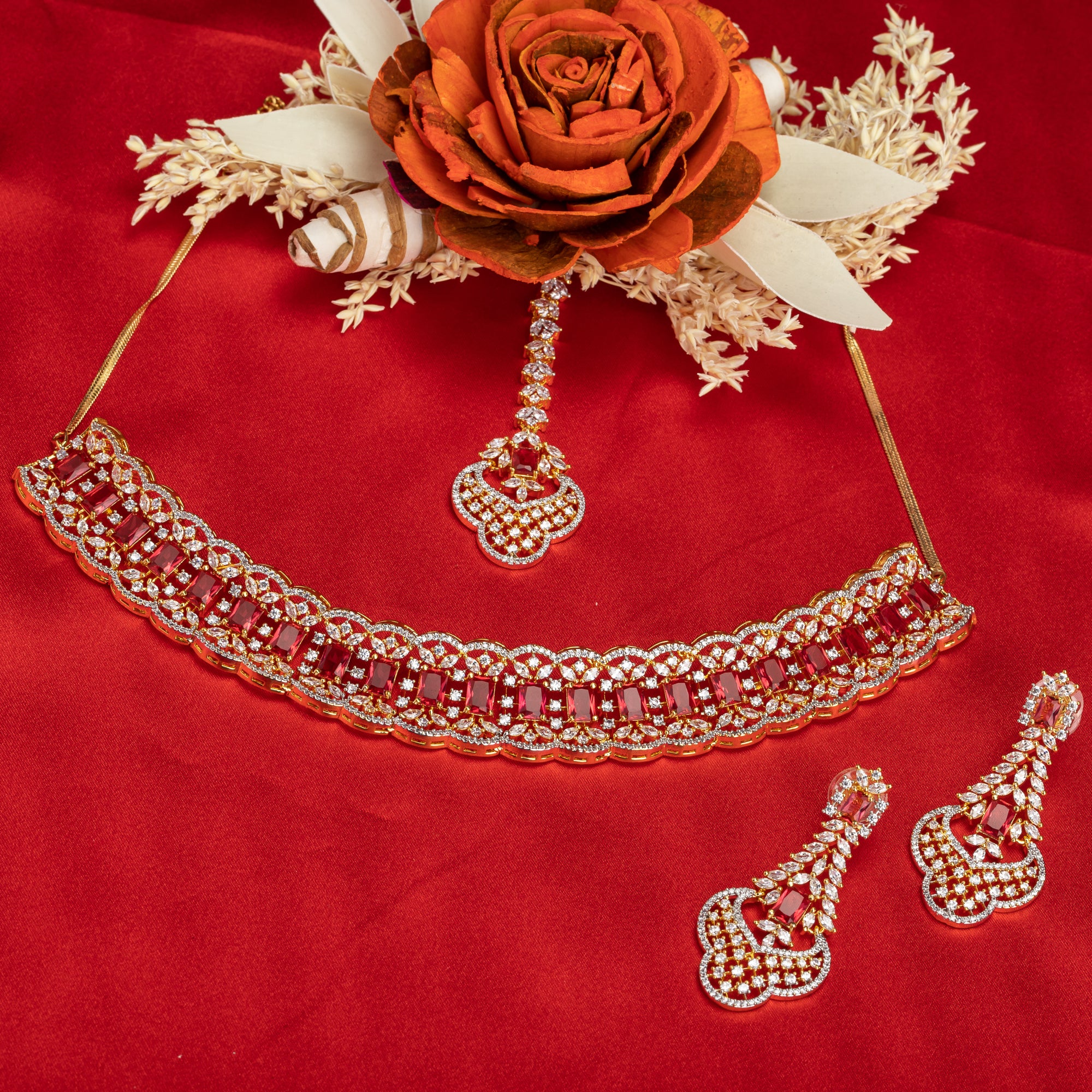 Red zircon bridal necklace set features intricate designs, perfect for a regal wedding look.
