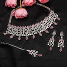 Pink pearl and white zircon bridal choker set with earrings and maangtika.
