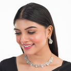 White zircon stone-studded short necklace set with matching earrings for timeless elegance.
