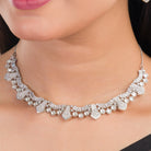 White zircon stone-studded short necklace set with matching earrings for timeless elegance.
