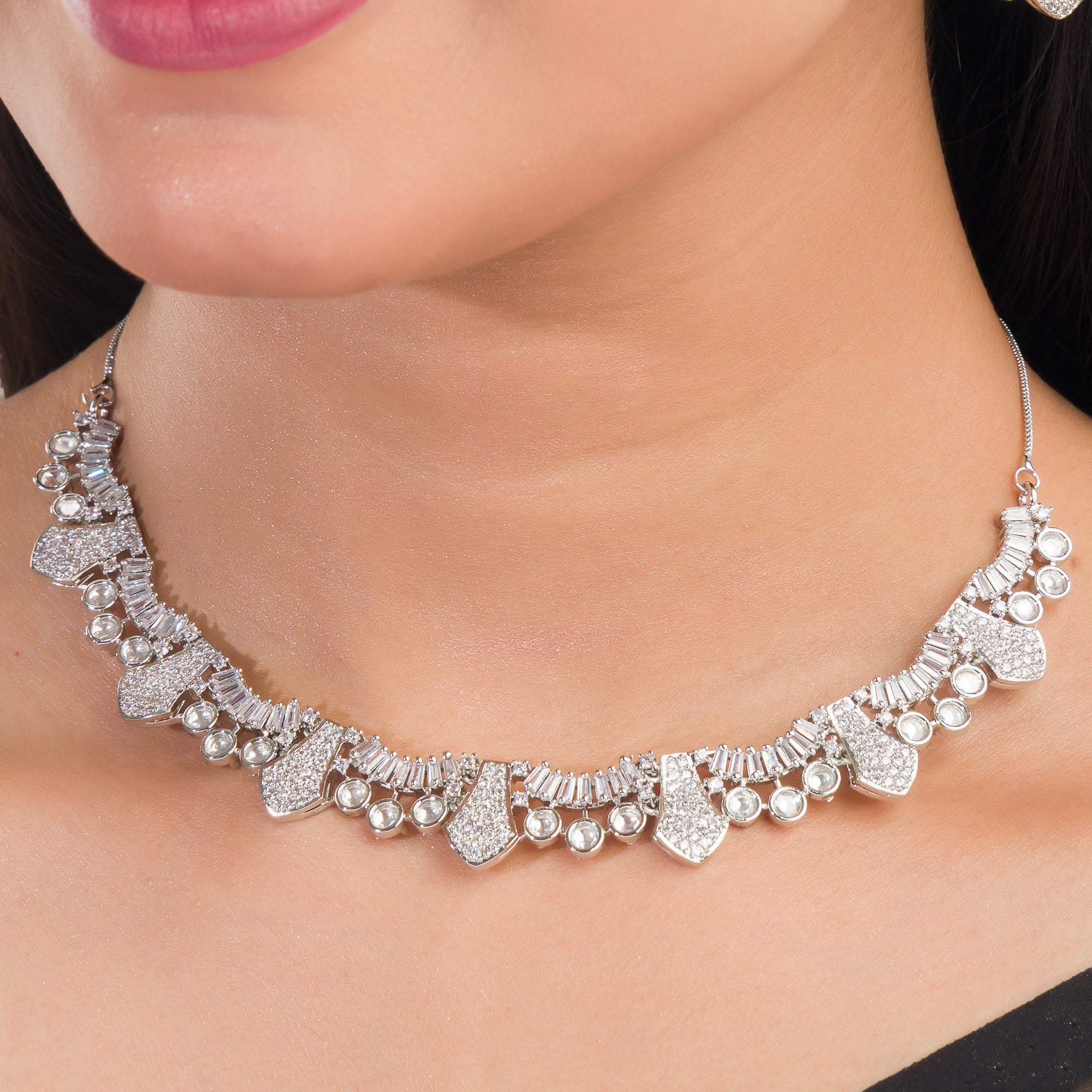 White zircon stone-studded short necklace set with matching earrings for timeless elegance.
