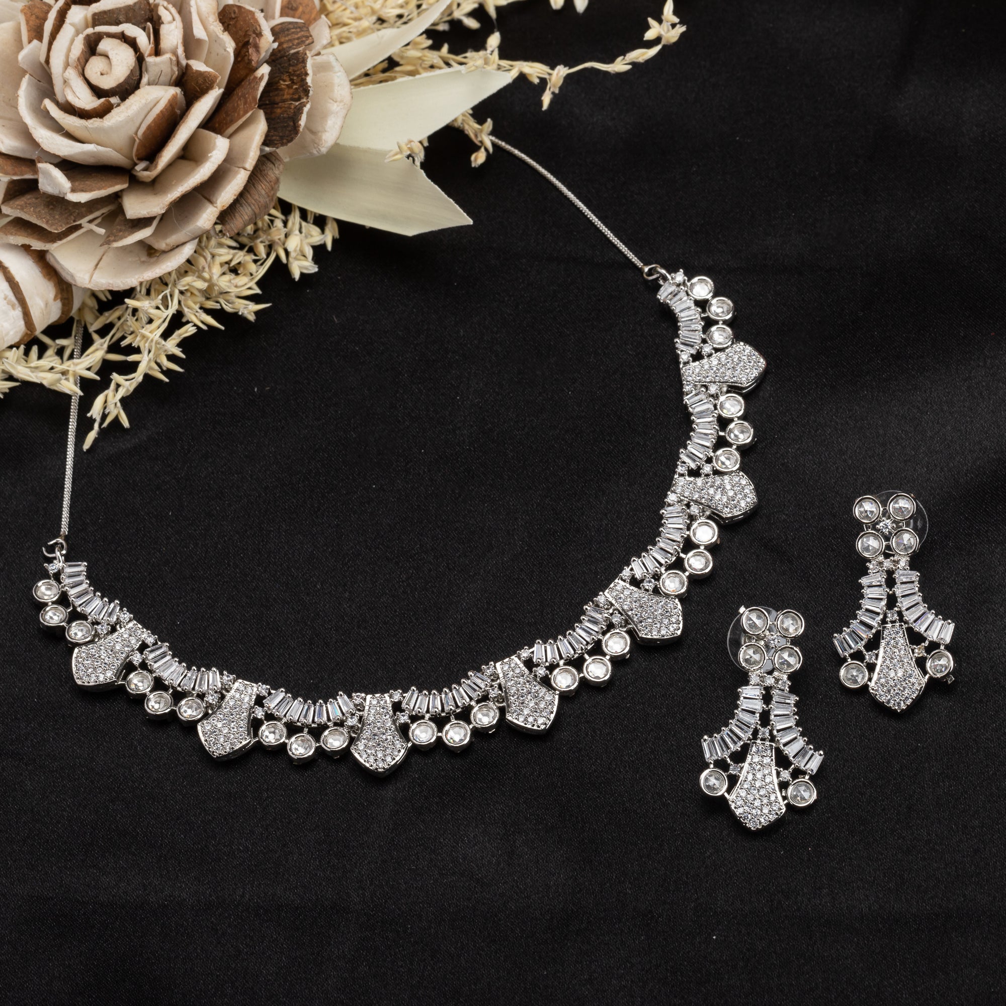 White zircon stone-studded short necklace set with matching earrings for timeless elegance.
