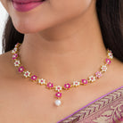 Pink pearl floral necklace set with matching earrings for timeless elegance and beauty.
