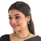 Black polished necklace set with golden and white zircon stones for an elegant and striking contrast.
