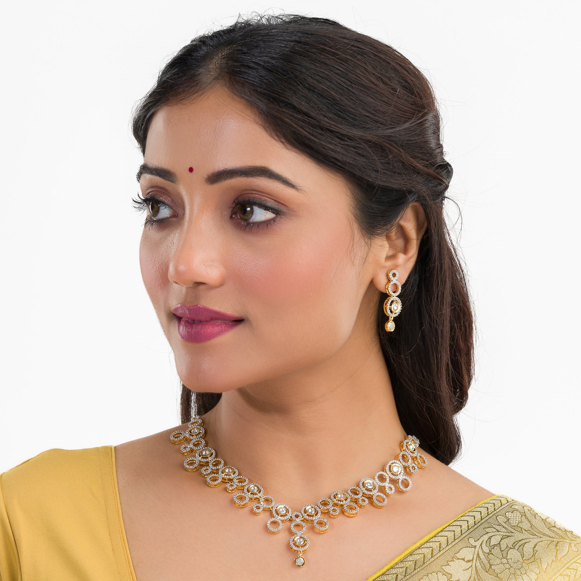 Golden polish zircon necklace set with matching earrings, offering luxury and elegance.
