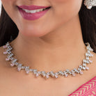 Orchid-colored zircon necklace set with matching jhumkas for an elegant party look.
