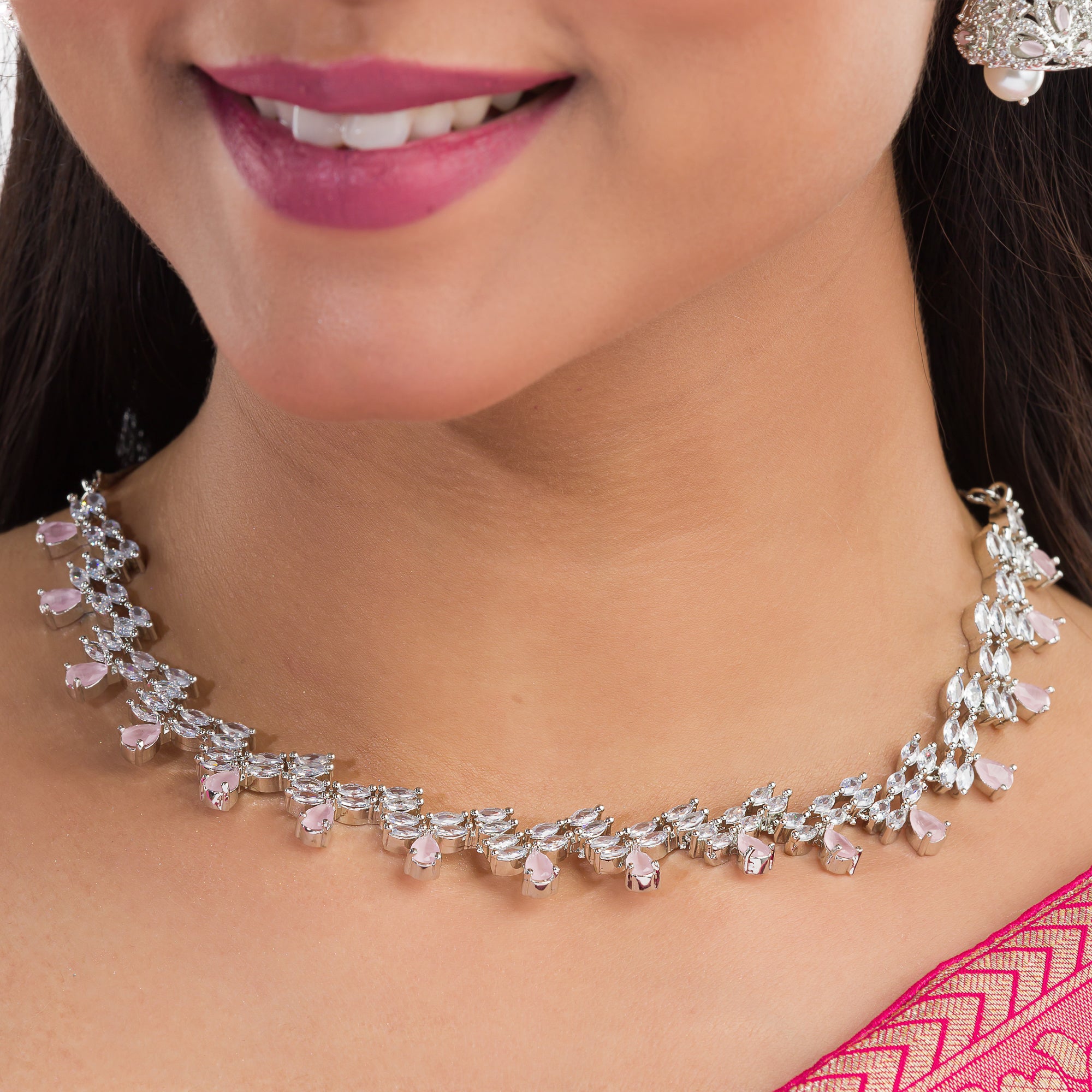 Orchid-colored zircon necklace set with matching jhumkas for an elegant party look.
