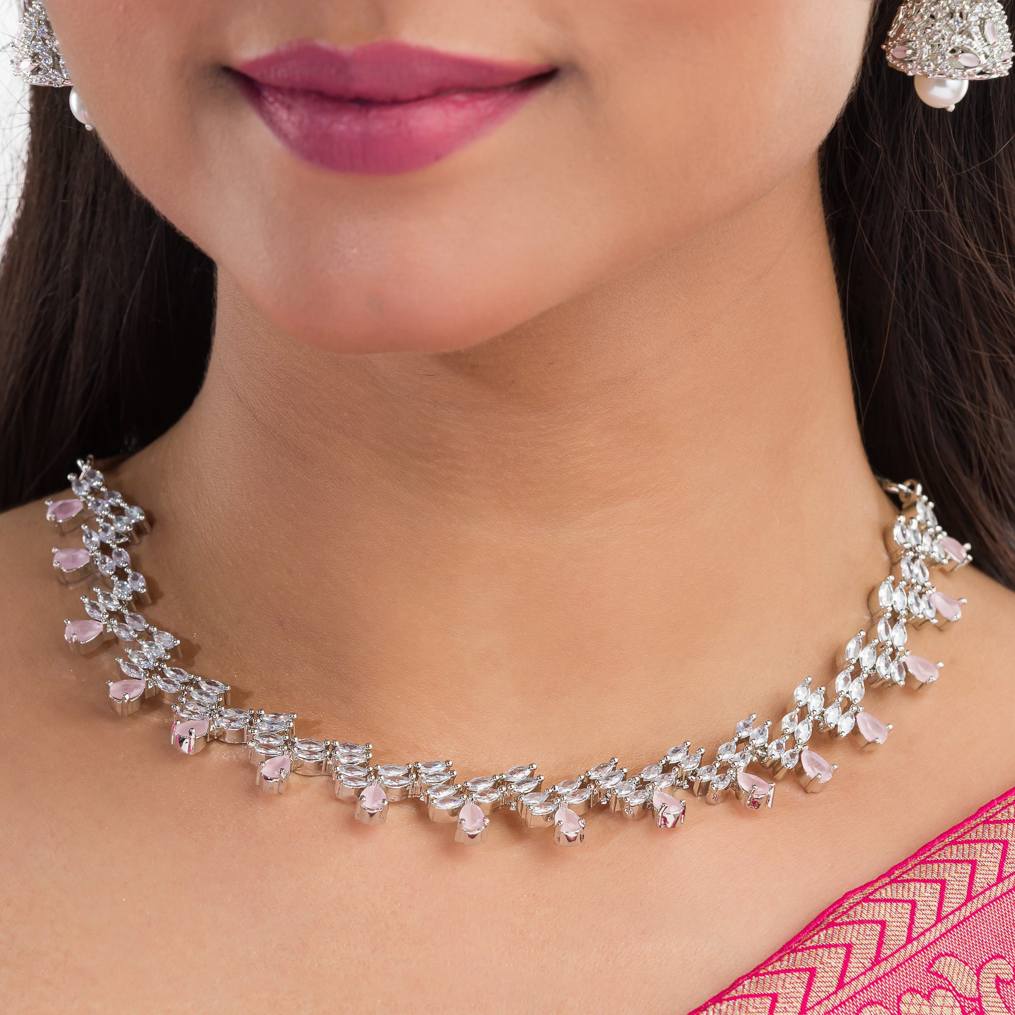 Orchid-colored zircon necklace set with matching jhumkas for an elegant party look.
