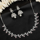 Orchid-colored zircon necklace set with matching jhumkas for an elegant party look.
