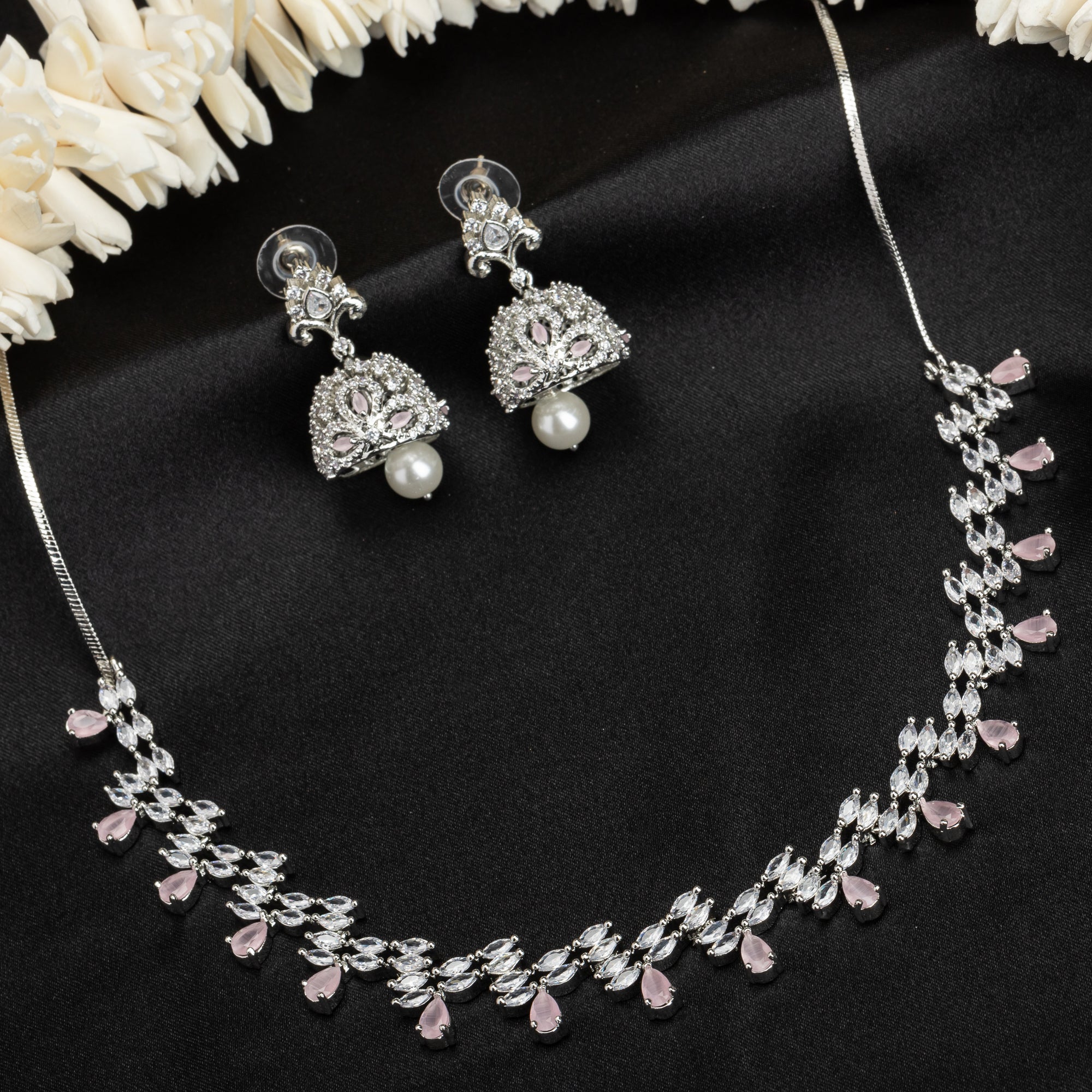 Orchid-colored zircon necklace set with matching jhumkas for an elegant party look.
