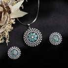 Floral zircon pendant set with turquoise and white stones, paired with matching earrings.

