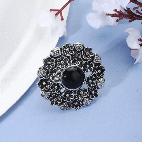 Vintage oxidized silver finger ring with intricate patterns and an antique finish.
