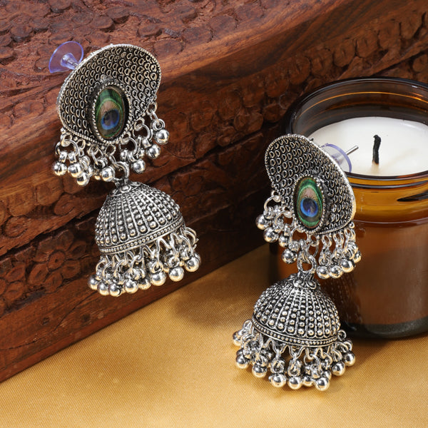 "Exquisite oxidized jhumkas with a beautifully crafted peacock feather design, perfect for festive occasions."
