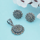 Graceful 925 silver pendant and earrings with intricate floral design for timeless elegance.
