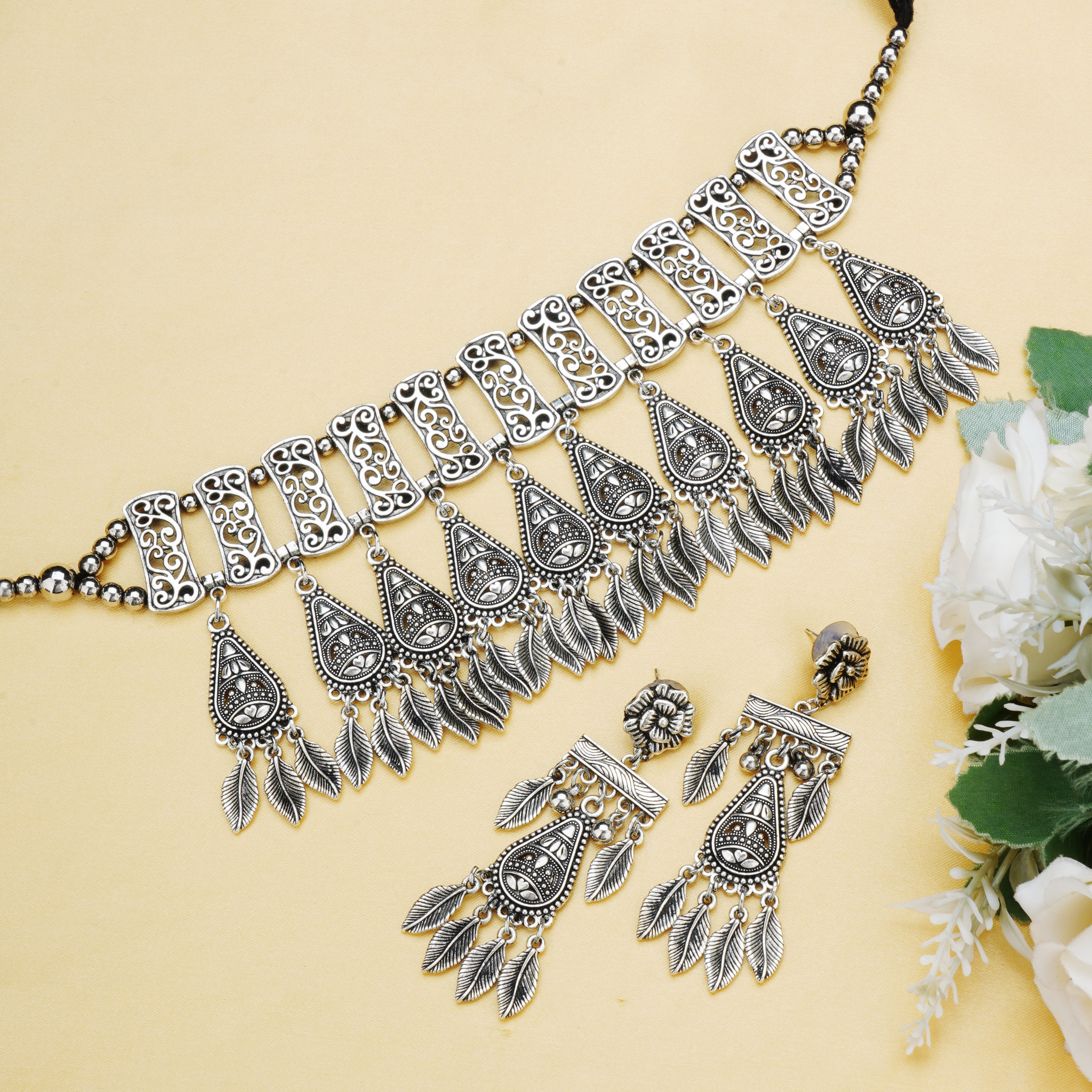Stylish oxidized choker set with matching earrings and bracelet for a complete festive ensemble.
