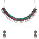 Elegant oxidized necklace set with green and pink stones, paired with matching jhumka earrings.
