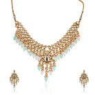Stunning Kundan choker necklace with exquisite craftsmanship and embedded pearls for bridal look.

