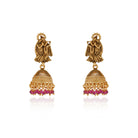  Radha Krishna temple necklace set with red pearls, showcasing intricate gold-tone craftsmanship.
