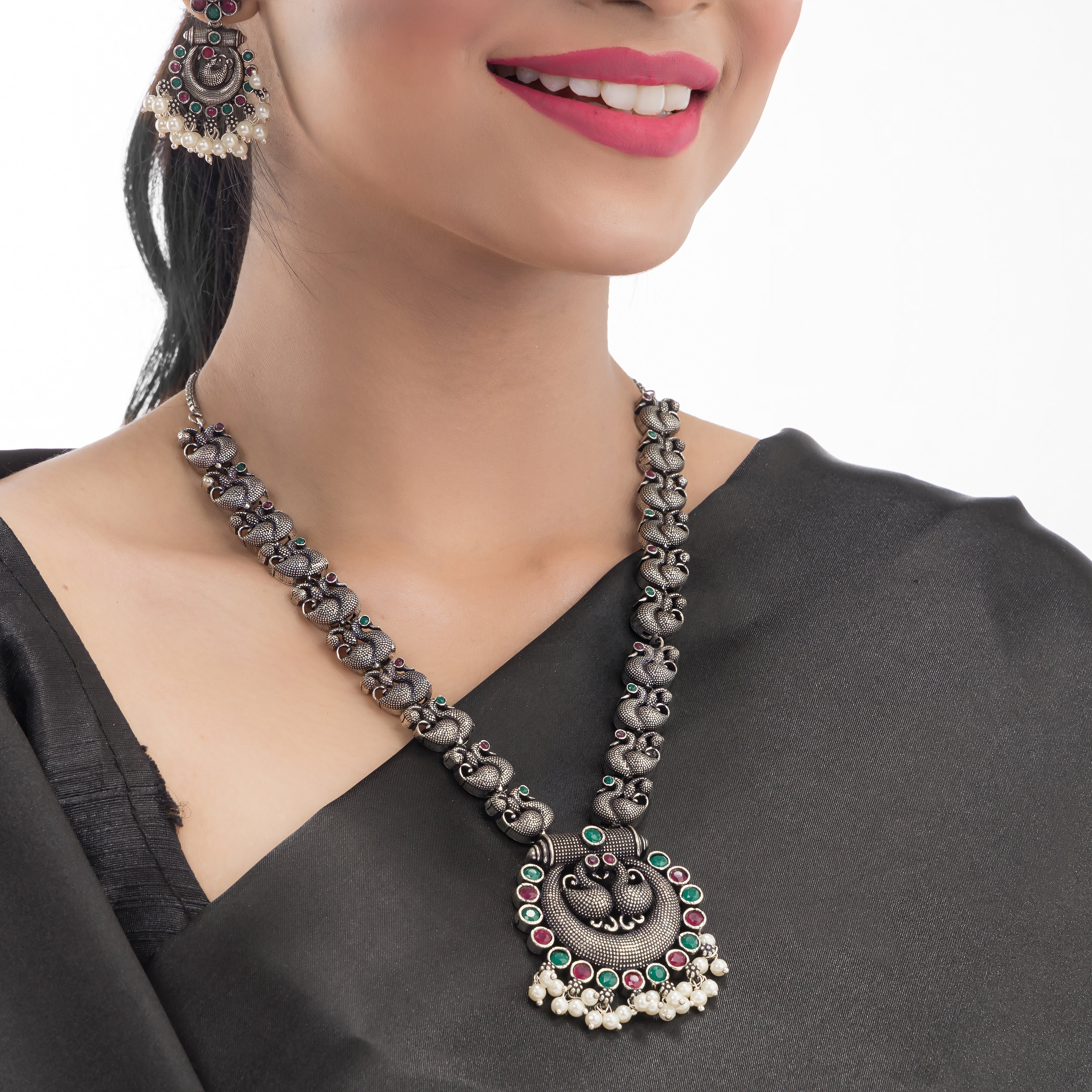 Intricate oxidized necklace set with a beautiful peacock design for a festive look.

