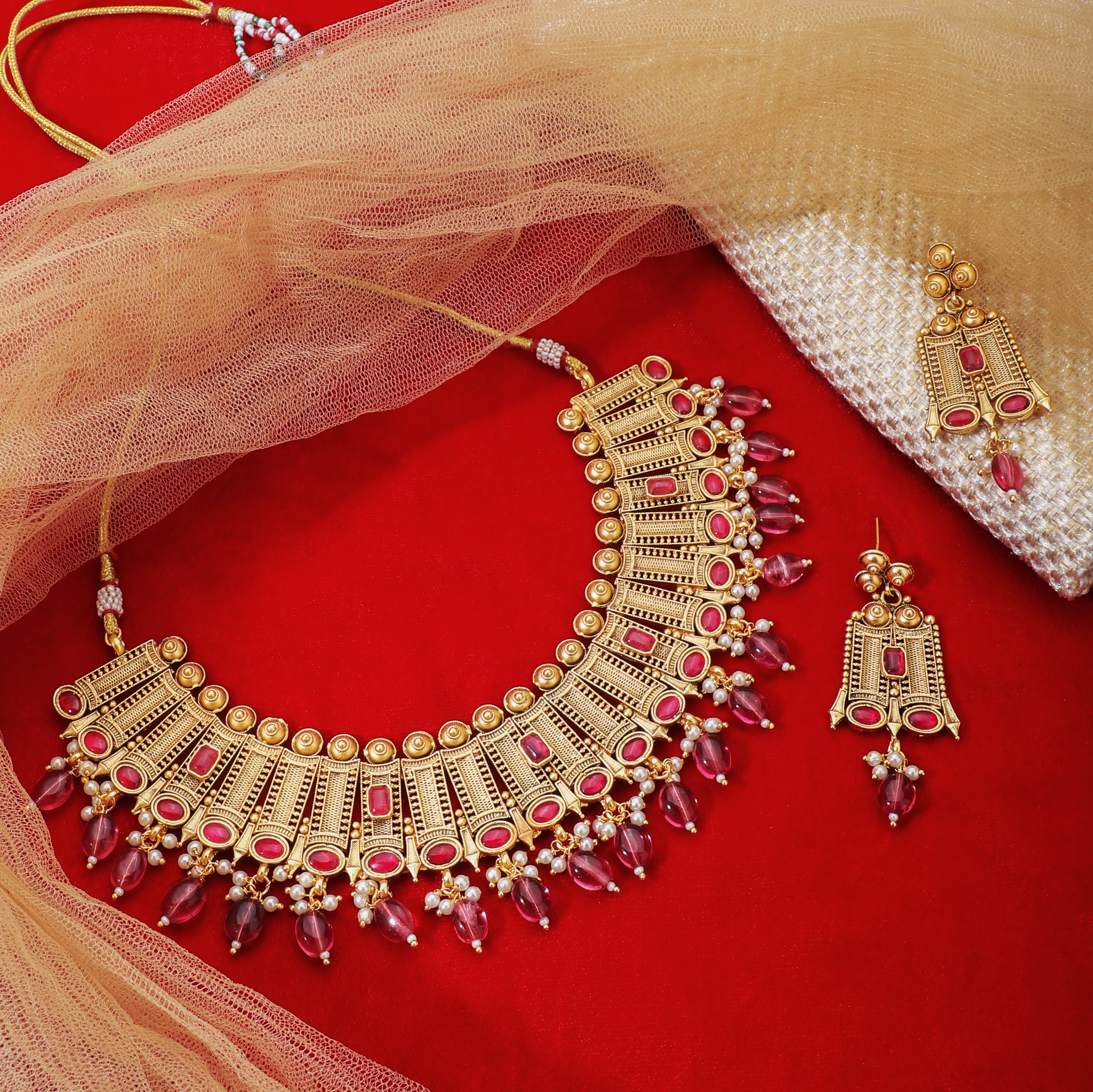 Elegant gold-tone choker necklace set with matching earrings, perfect for festive occasions
