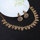 Gold-tone short necklace set with vibrant multicolor stones and matching earrings, perfect for celebrations.
