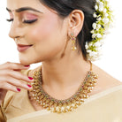 "Gold-tone short necklace set with multicolor stones and zircon accents for a festive look."
