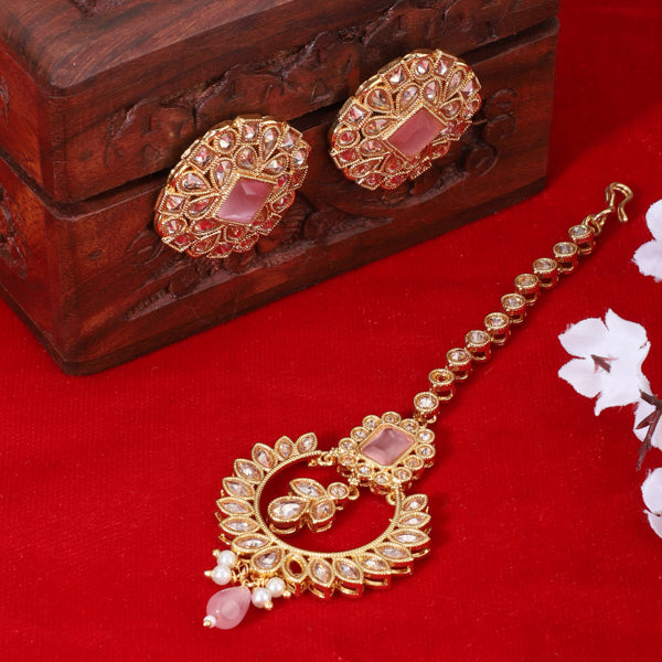 "Kundan-studded earrings with matching maang tika, a timeless set for a classic festive look."

