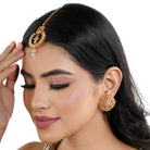 "Kundan-studded earrings with matching maang tika, a timeless set for a classic festive look."
