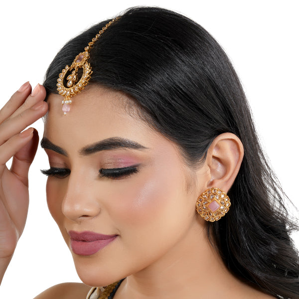 "Kundan-studded earrings with matching maang tika, a timeless set for a classic festive look."
