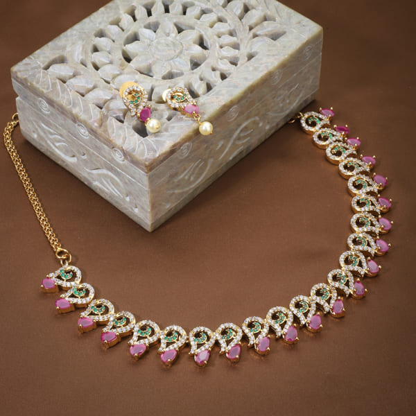 Vibrant multicolor stone-studded goldtone necklace set with matching earrings for festive elegance.
