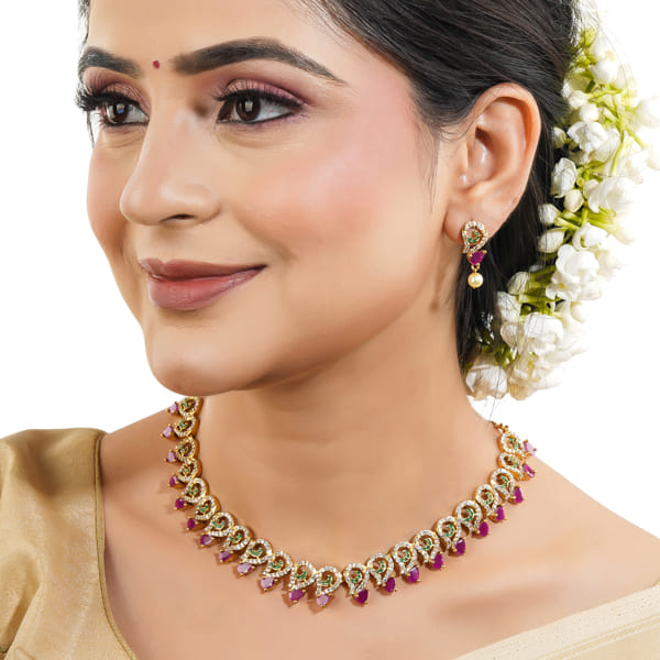 Vibrant multicolor stone-studded goldtone necklace set with matching earrings for festive elegance.
